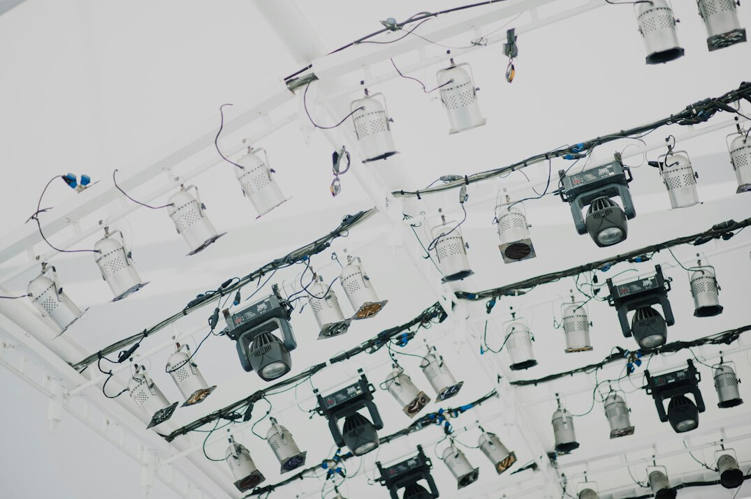 Professional television cameras and lighting rig in an empty studio